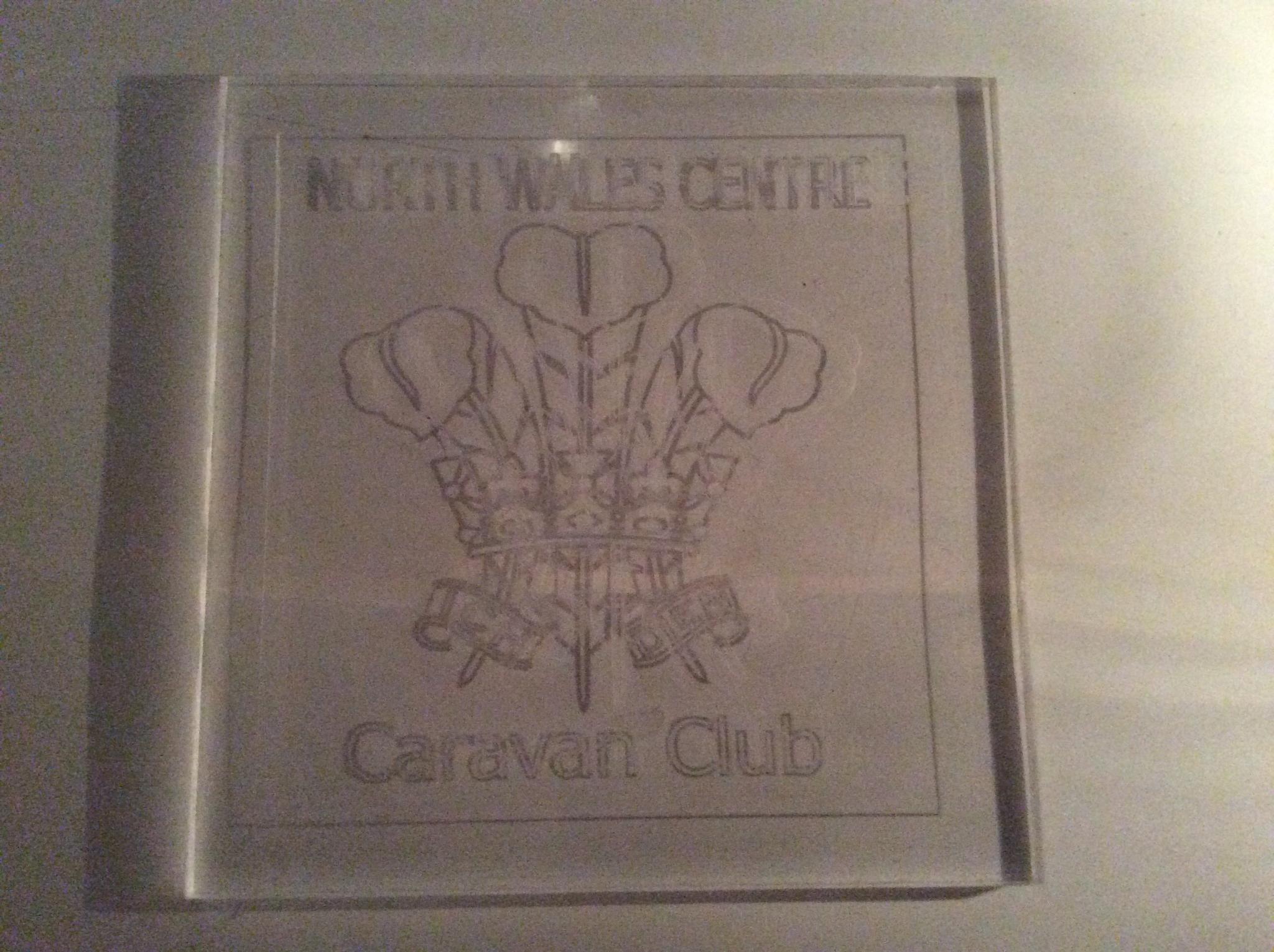 A 5mm piece of clear acrylic approx 110mm square
Engraved 0.3 mm deep with the welsh feathers emblem
Sorry for the poor quality pic